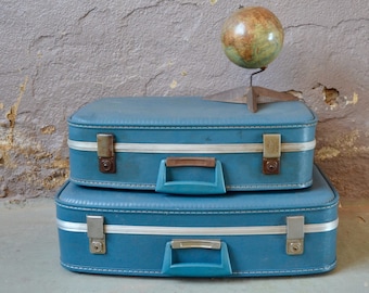 Old vintage blue suitcase boho travel decoration