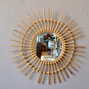Rattan sun mirror in vintage French boho and country chic style