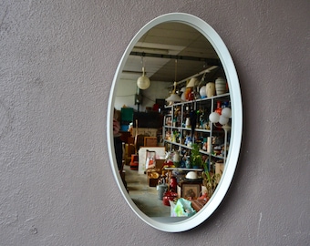 Large white oval mirror with space age and vintage design