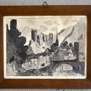 May include: A framed black and white ink drawing of a medieval village nestled in a valley. The drawing depicts a castle on a hilltop with a bridge crossing a river in the foreground.