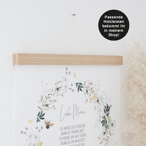 May include: A white poster with a floral wreath and the text "Liebe Marie" in black script. The text below the wreath reads "Ich werde dich tr&ouml;sten, wenn du traurig bist. Ich werde dir Halt geben, wenn du ihn brauchst. Wenn du dir helfen."