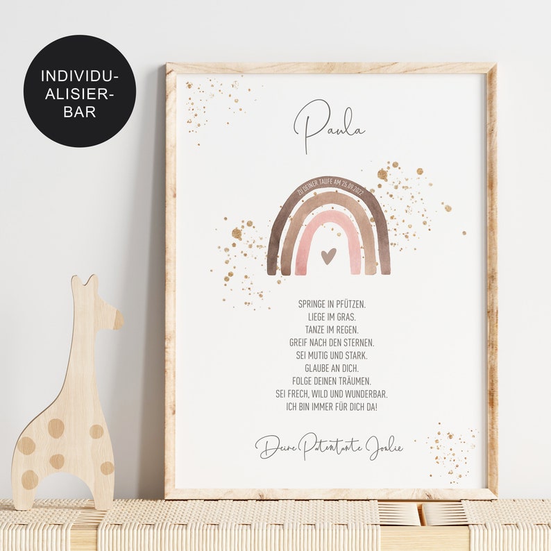 May include: A watercolor rainbow with a pink heart in the center, surrounded by gold glitter. The text "Paula" is at the top of the image, and the text "Deine Patentante Joalie" is at the bottom. The text "Geboren Heute am 15.03.2022" is below the name.