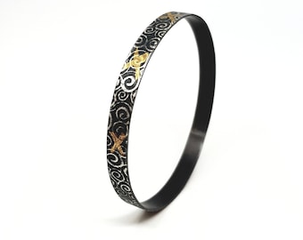 Noa by Fedha -oxidised sterling silver bangle, rolled with spiral pattern, Keum Boo detail