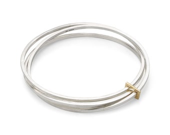 Clara by Fedha - stylish set of three polished sterling silver bangles with solid gold link, uncluttered, understated
