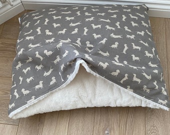 Cozy snuggle bed with dachshund print and choice of luxury fleece or faux fur lining.