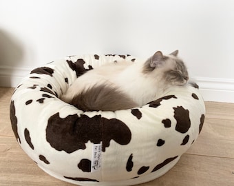 Cow print donut pet bed for cats dogs or small animals.