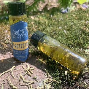 May include: Two small glass bottles with gold liquid and a blue label that reads "Gypsy Spirit Protection Potion for Mental & Physical Protection for External Use Only GypsySpirit.com".