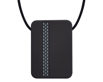 May include: A black square pendant with a gray textured stripe down the center, hanging from a black cord.