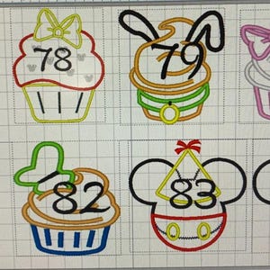 May include: Embroidered designs featuring numbers 77 through 84, each incorporated into a cupcake or Mickey Mouse head design. The cupcakes have various colors and decorations, including bows and character-themed elements.