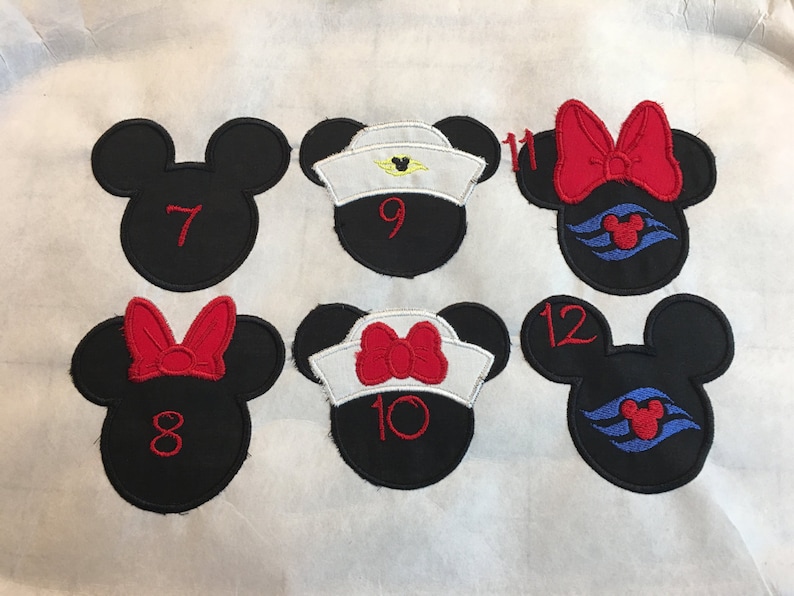 May include: Embroidered black Mickey Mouse head patches with red numbers and bows. Some have sailor hats and cruise ship logos. Numbers 7, 8, 9, 10, 11, and 12 are visible. These patches are likely for crafting or apparel.