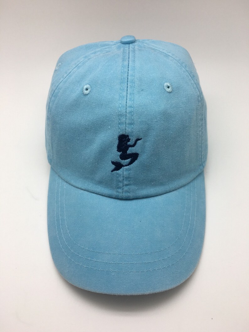 Puede incluir: Una gorra de b&eacute;isbol azul claro con un dise&ntilde;o de sirena bordado en azul oscuro.