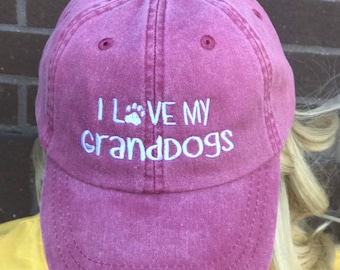 May include: A pink baseball cap with the text "I love my granddogs" embroidered in white on the front.