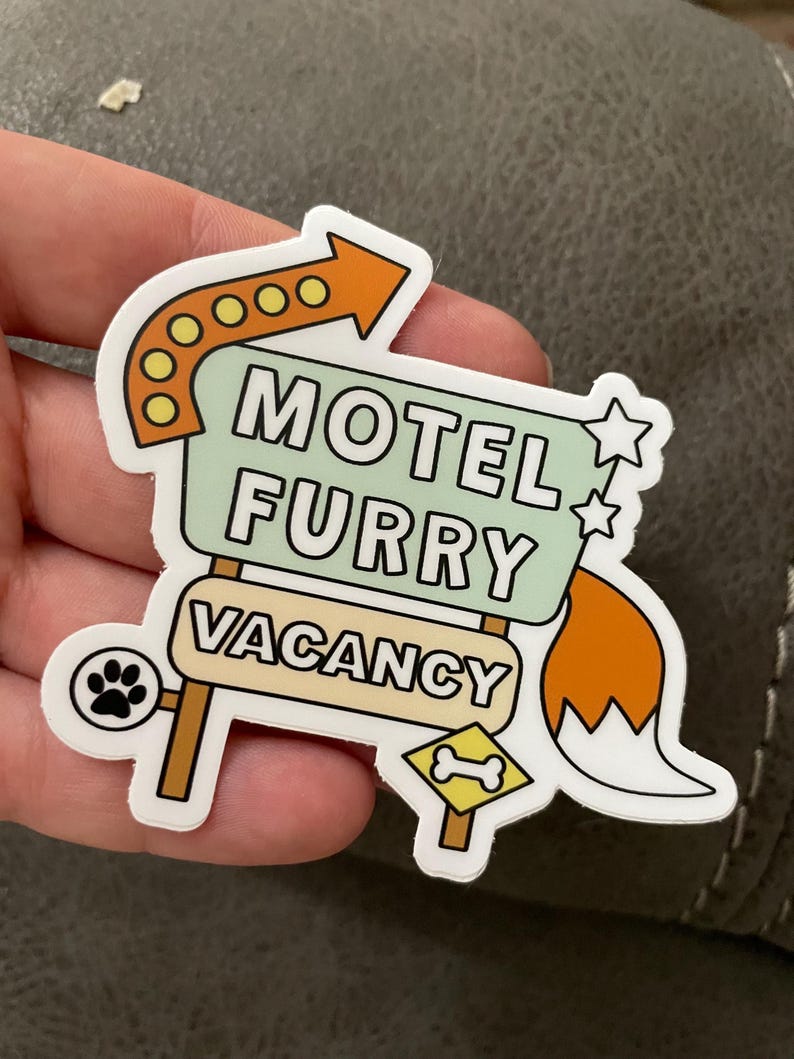 sticker cut into the shape of a motel sign with arrow, stars and tail attached. text reads motel furry — vacancy with a paw print and bone symbol underneath.
