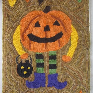 May include: A handmade Halloween-themed rug featuring a smiling jack-o'-lantern with black eyes and mouth. The pumpkin has yellow arms and is wearing blue boots and striped green and black legs. It holds a black cat-shaped treat bag. The rug has a brown background with colorful triangles.
