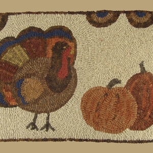 May include: Hand-hooked rug featuring a turkey and two pumpkins. The turkey has a fan of blue, brown, and yellow feathers. The pumpkins are orange and brown. The rug has a cream-colored background and a brown border.