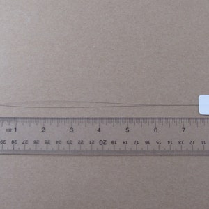 ruler showing total length of punch needle threader