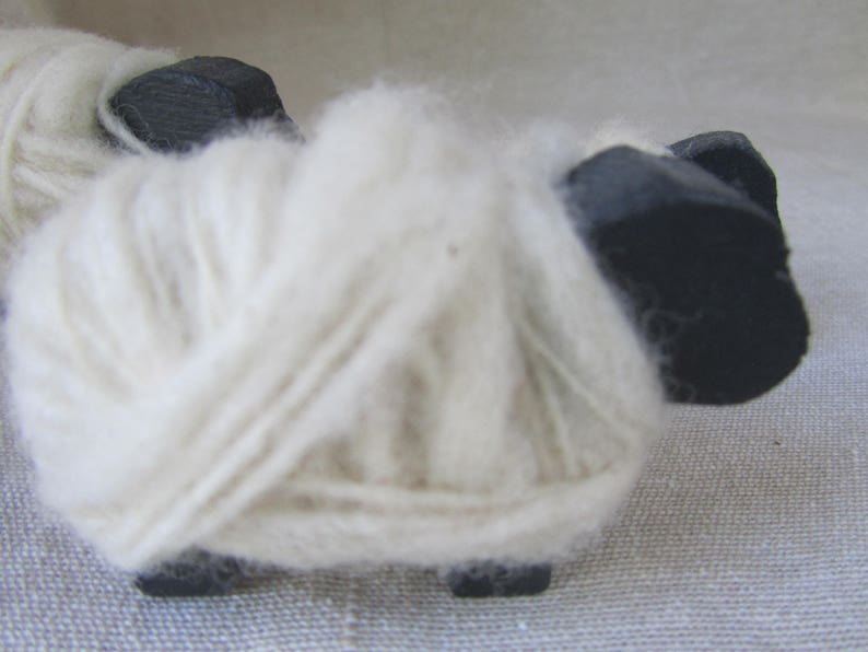 close-up of the hand-spun wool wrapped around wooden sheep