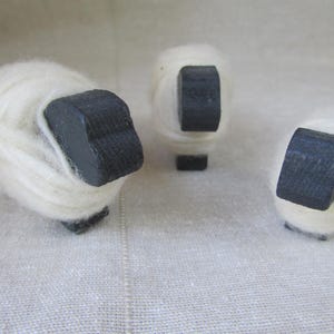 three hand painted sheep wrapped with hand spun wool yarn