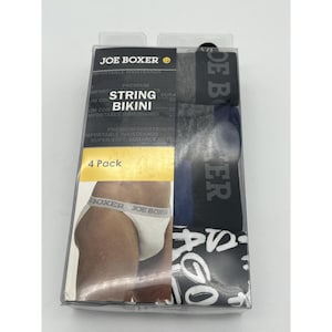 Op de afbeelding: Een vierpak Joe Boxer string bikini ondergoed in een doorzichtige plastic verpakking. De verpakking toont de merknaam en productdetails, waaronder "comfortabele taillebanden" en "superzacht, duurzaam katoen."