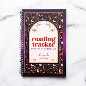May include: A spiral-bound reading tracker book with a dark purple cover featuring a floral and crescent moon pattern. The center displays an arched frame with the text reading tracker, book log & reading stats, and made by Novelly Yours.