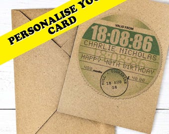 May include: A brown kraft paper greeting card and matching envelope. The card features a circular design resembling a vintage train ticket with the text 18:08:86, CHARLIE NICHOLAS, HAPPY 40TH BIRTHDAY, 480 months, and a circular stamp reading HULL YORKSHIRE.
