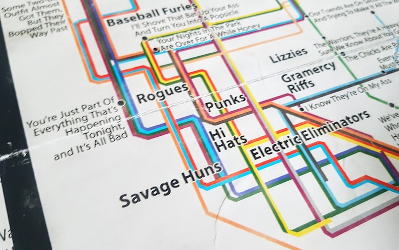May include: A colorful subway map with the names of different bands, including "Baseball Furies", "Rogues", "Punks", "Hi Hats", "Savage Huns", "Lizzies", "Gramercy Riffs", and "Electric Eliminators".