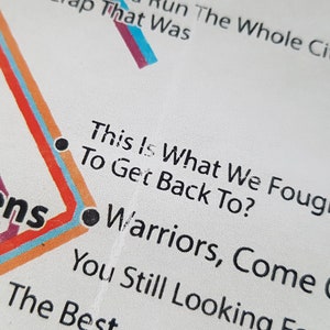 May include: A close-up of a white paper with black text. The text reads "This Is What We Fought All Night To Get Back To? Warriors, Come Out To Play You Still Looking For The Best"