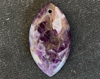 May include: A purple amethyst pendant with a teardrop shape and a hole at the top for stringing. The amethyst has a cloudy, white and purple pattern.