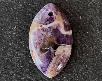 May include: A purple, white and brown amethyst pendant with a hole drilled through the top for a cord or chain.