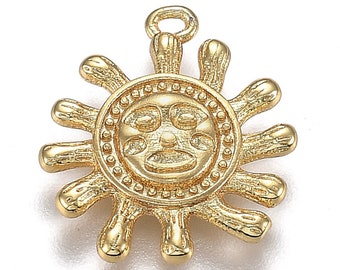 May include: Gold-toned sun charm with a face design and a textured surface. The charm has a loop at the top for attaching to a necklace or bracelet.