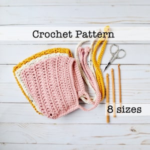 Może przedstawiać: Wzór na szydełkowy czepek dla niemowlęcia w kolorze różowym, białym i żółtym. Wzór zawiera 8 rozmiarów.