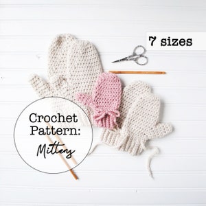 May include: Crochet pattern for mittens in 7 sizes. The image shows three pairs of mittens in various colours, including beige and pink. The mittens are laid out on a white surface.