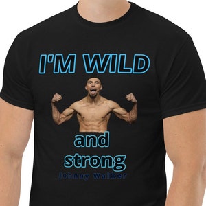 May include: Black t-shirt with a blue and white graphic of a man flexing his muscles. The text "I'M WILD and strong" is written in blue and white. The text "Johnny Walker" is written in white below the graphic.