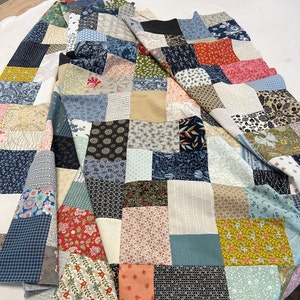 scrappy patchwork quilt handmade multi color blue green pink orange yellow black and white. floral and geometric prints. all soft cotton fabrics