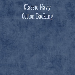 May include: A navy blue fabric with a textured appearance. The words "Classic Navy" and "Cotton Backing" are written in white script across the top of the fabric.