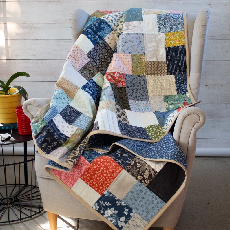 A handmade scrappy patchwork quilt crafted with unique multicolor cotton prints. Available from lap to king sizes, this heirloom-quality quilt adds warmth, character, and charm to any home.