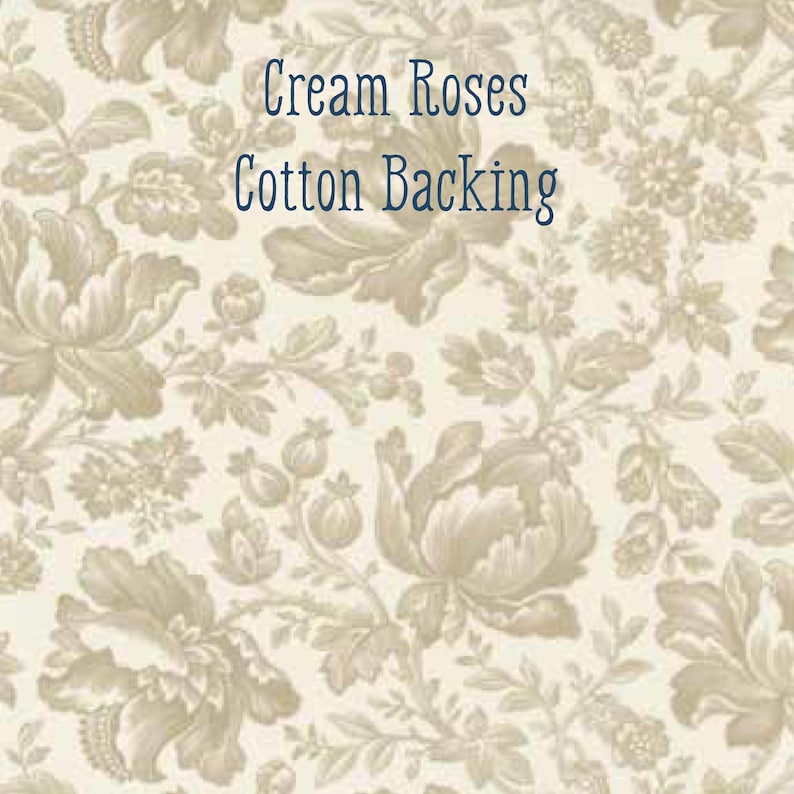 May include: Cream-coloured floral fabric featuring a repeating pattern of roses and foliage. The text "Cream Roses Cotton Backing" is displayed in dark blue. The fabric has a vintage, classic aesthetic.