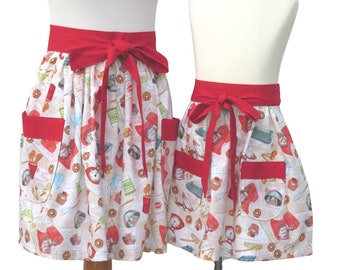 Mother & Daughter Matching Cooking Themed Half Aprons in a Cute Cotton Print with Kitchen Gadgets, Recipes and Baking Supplies