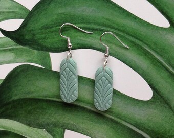 Oval polymer clay earrings, textured oblong shape.