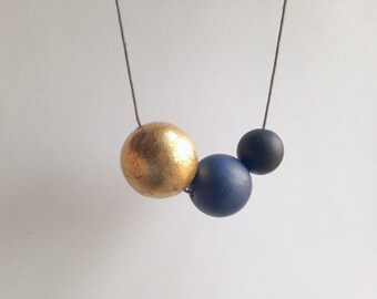 Polymer clay beaded necklace. Minimalistic spheres in gold, blue, black. Simple round beads.