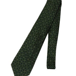 May include: A green tie featuring a repeating square pattern. The tie is displayed at an angle against a white background, highlighting its design and texture. The pattern is a darker green on a lighter green base.