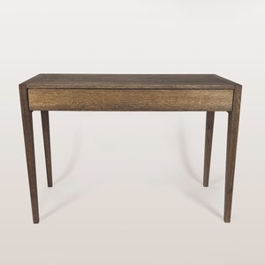 Minimalistic solid dark oak wood desk with drawer.
