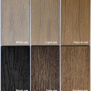 May include: Six rectangular wood veneer samples arranged in two rows. The top row features White oak, Light oak, and Natural oak. The bottom row displays Black oak, Dark oak, and Smoked oak. Each sample shows a distinct wood grain texture.