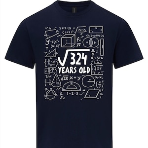 May include: Dark blue t-shirt with a white graphic of mathematical equations and the text "√324 YEARS OLD". The design includes geometric shapes, formulas, and numbers, creating a unique, educational theme.