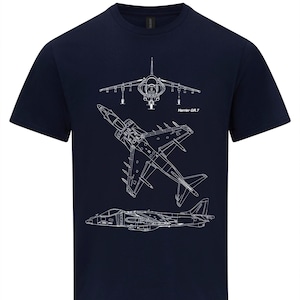 May include: A navy blue t-shirt featuring a white outline of a Harrier GR.7 jet plane. The design shows three different views of the aircraft.