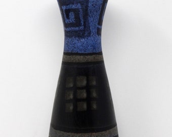 May include: A tall, ceramic vase with a flared top and a wide base. The vase features a blue speckled pattern with geometric designs and black and gray bands. The vase is approximately 12 inches tall.