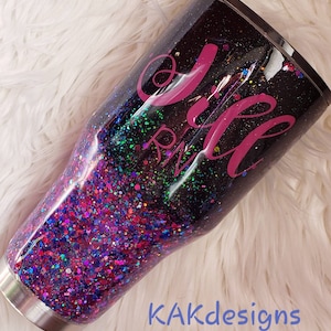 May include: A black and purple glitter tumbler with a pink design that says "Jill RN".