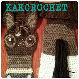 May include: Crocheted horse head and legs with a brown and white color scheme. The horse has a black tail and a white nose.