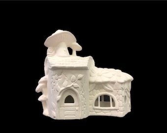 May include: White ceramic fairy house with a mushroom roof and a vine-covered exterior. The house has a small door and a window.