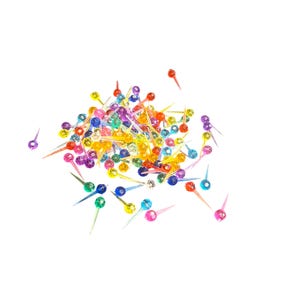 May include: A pile of colorful plastic Christmas light bulbs with a pointed tip. The bulbs are in various shades of red, orange, yellow, green, blue, and purple.